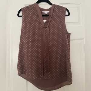 Sleeveless blouse with tie in front. New with tags